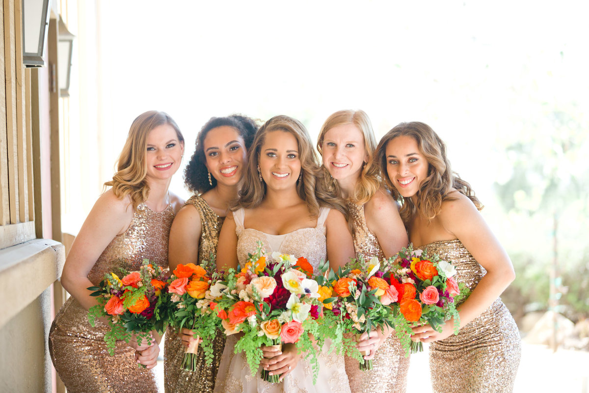 Bridal party of bridesmaids in rose gold dresses
