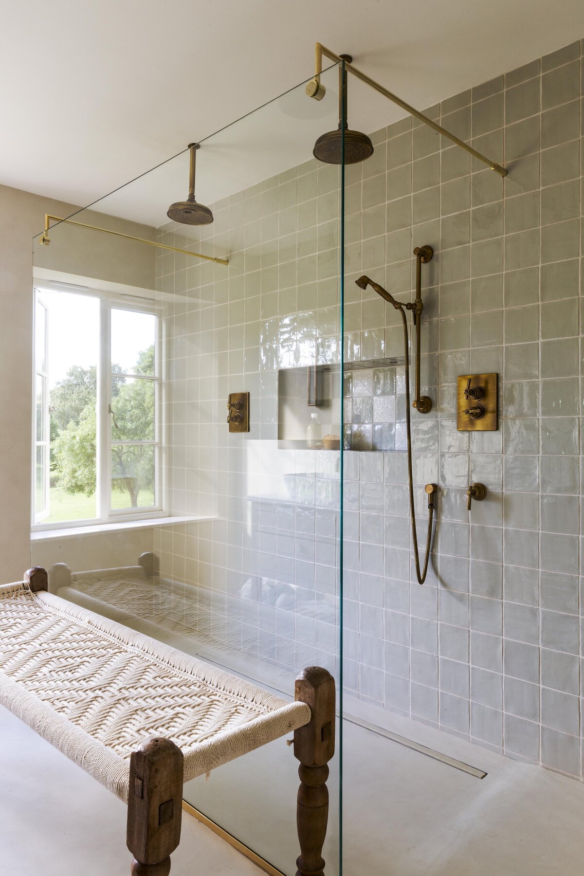 Glass shower screen with brass hardware and custom bench