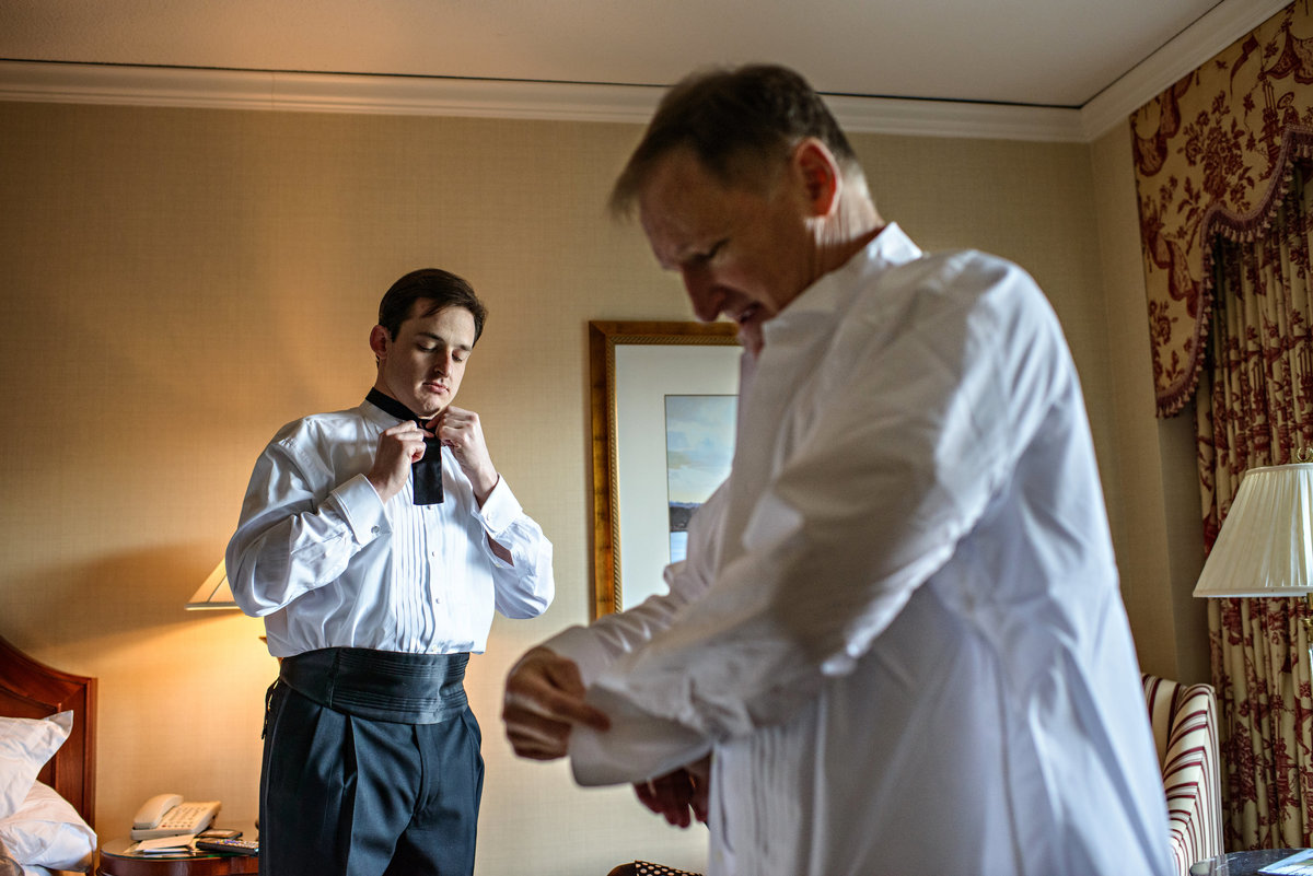 A groom gets ready with his dad at a hotel in Philadelphia.