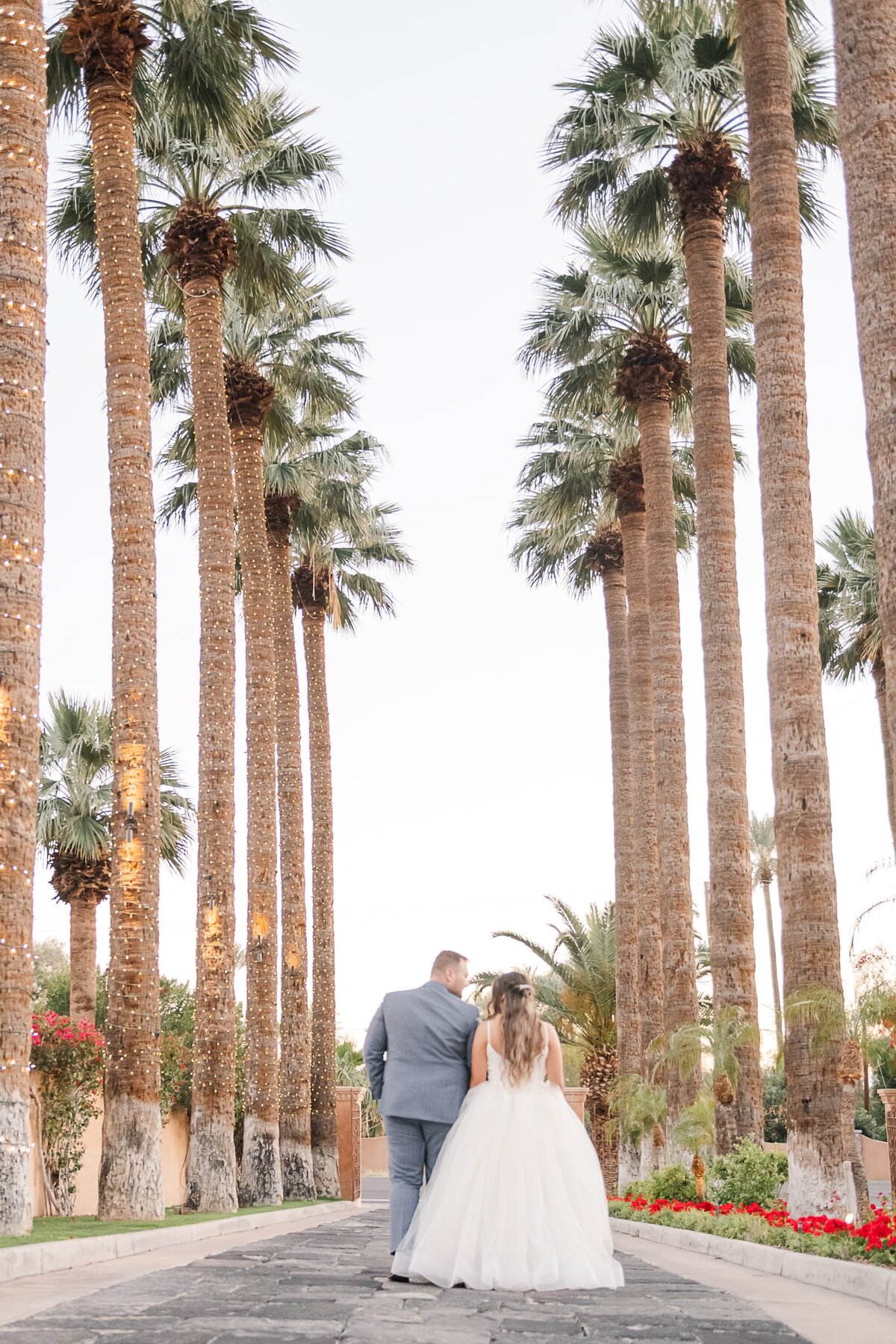 Scottsdale-Wedding-Photographers-Royal-Palms-Bride-Groom-Walking-1568