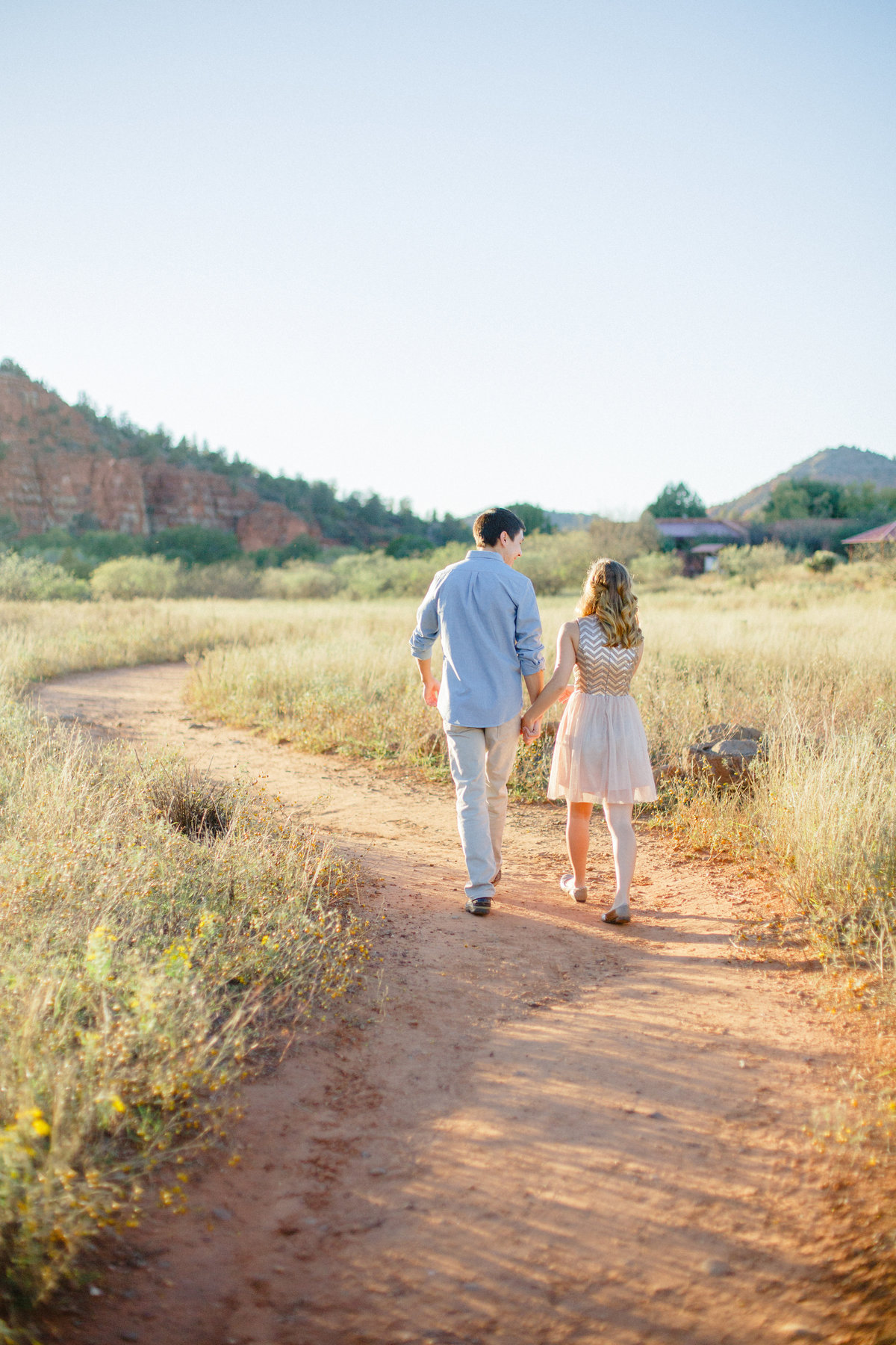 walking down dirt path in sedona arizona park for engagement photography