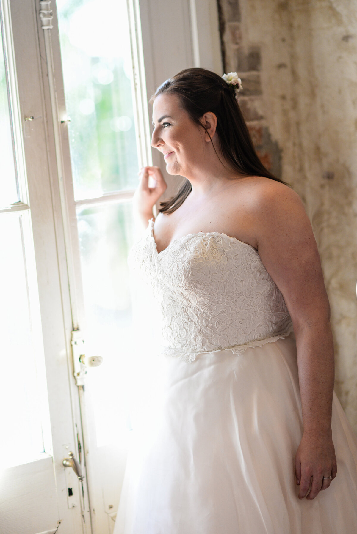 Beautiful bridal portrait photography: bride gazes out a window at Race & Religious in New Orleans, Nola Wedding Photographer