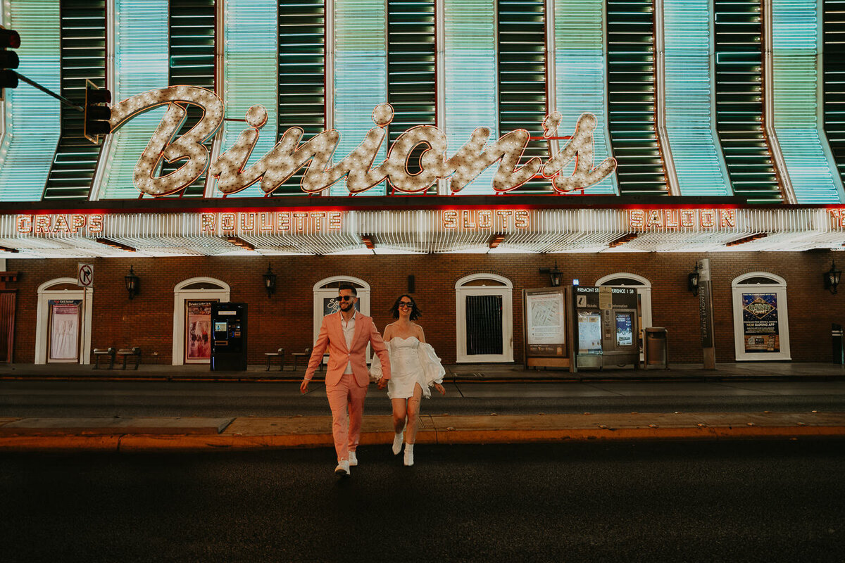 Bride and Groom wedding portraits in Fremont Street after their wedding ceremony at Sure Thing Chapel.