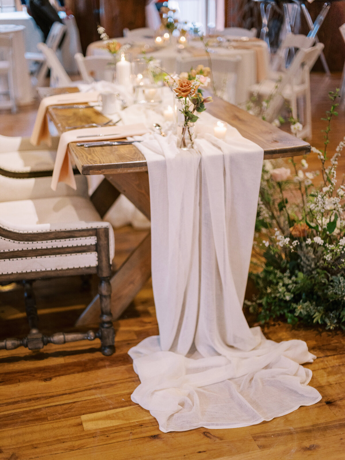 romantic sweetheart table with white flowy runner