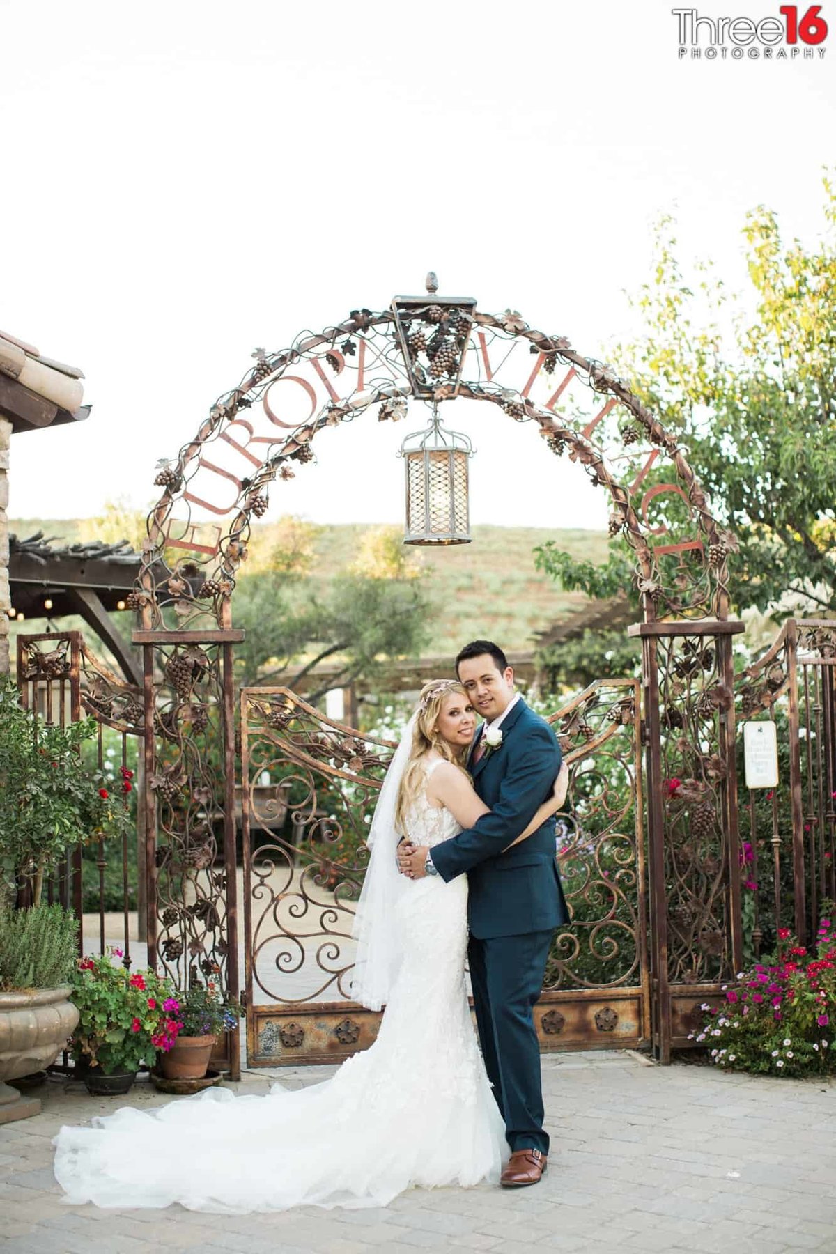 Husband and Wife pose in front of Europa Village Winery Wedding Venue