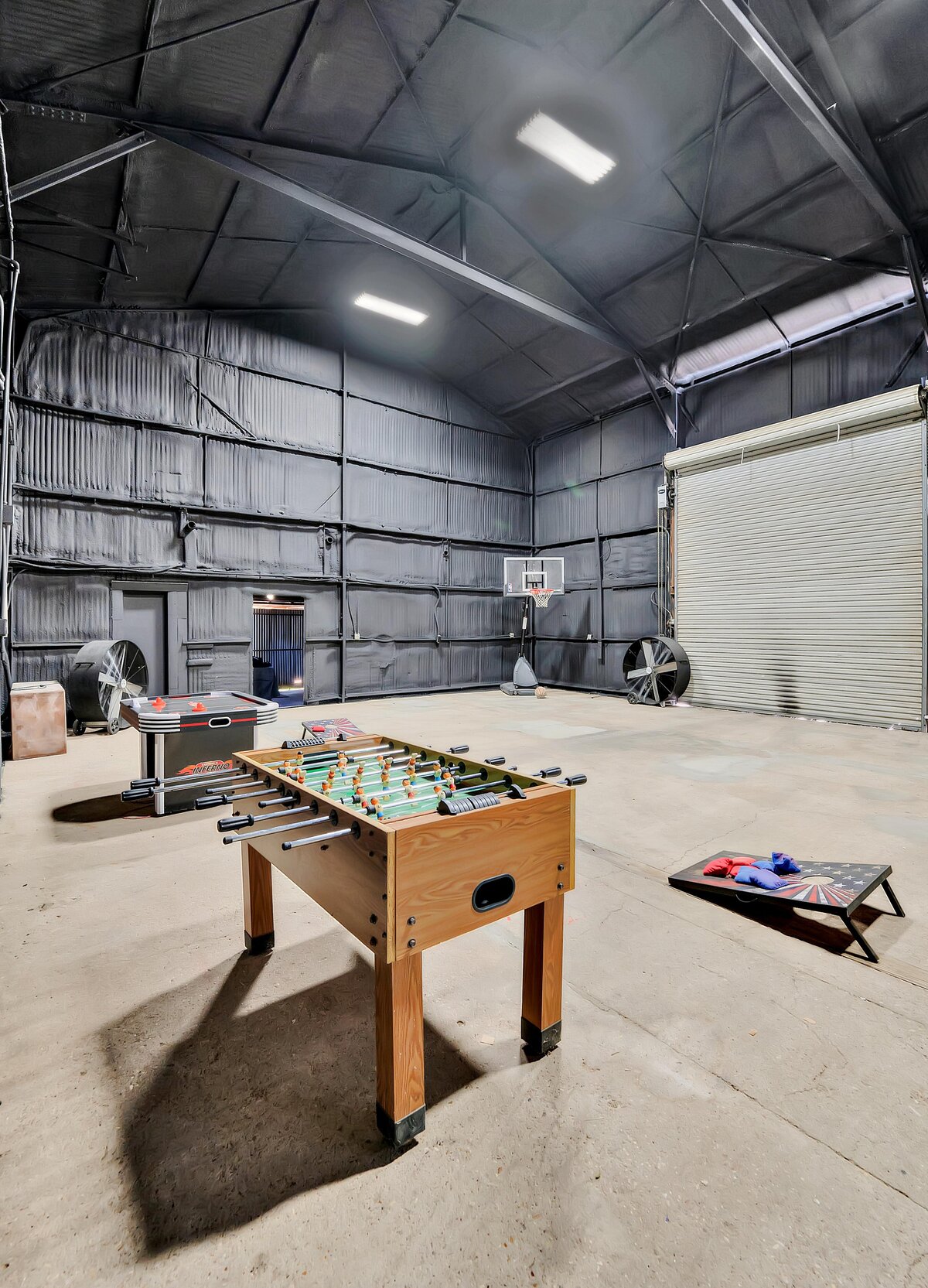 Garage entertainment room with game tables in this four-bedroom, four-bathroom vacation rental home and guest house with free WiFi, fully equipped kitchen, firepit and room for 10 in Waco, TX.