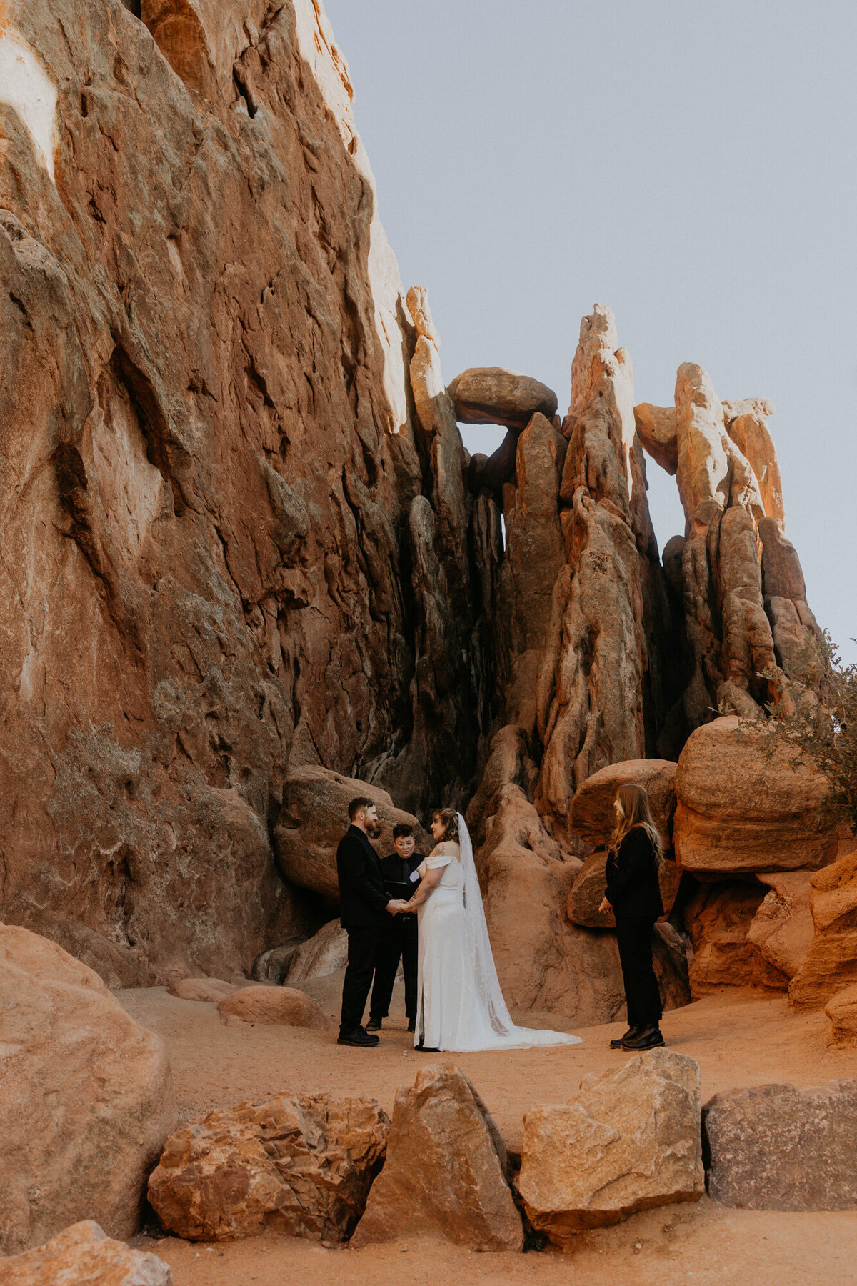 bride and groom having their ceremony at Garden of the Gods park