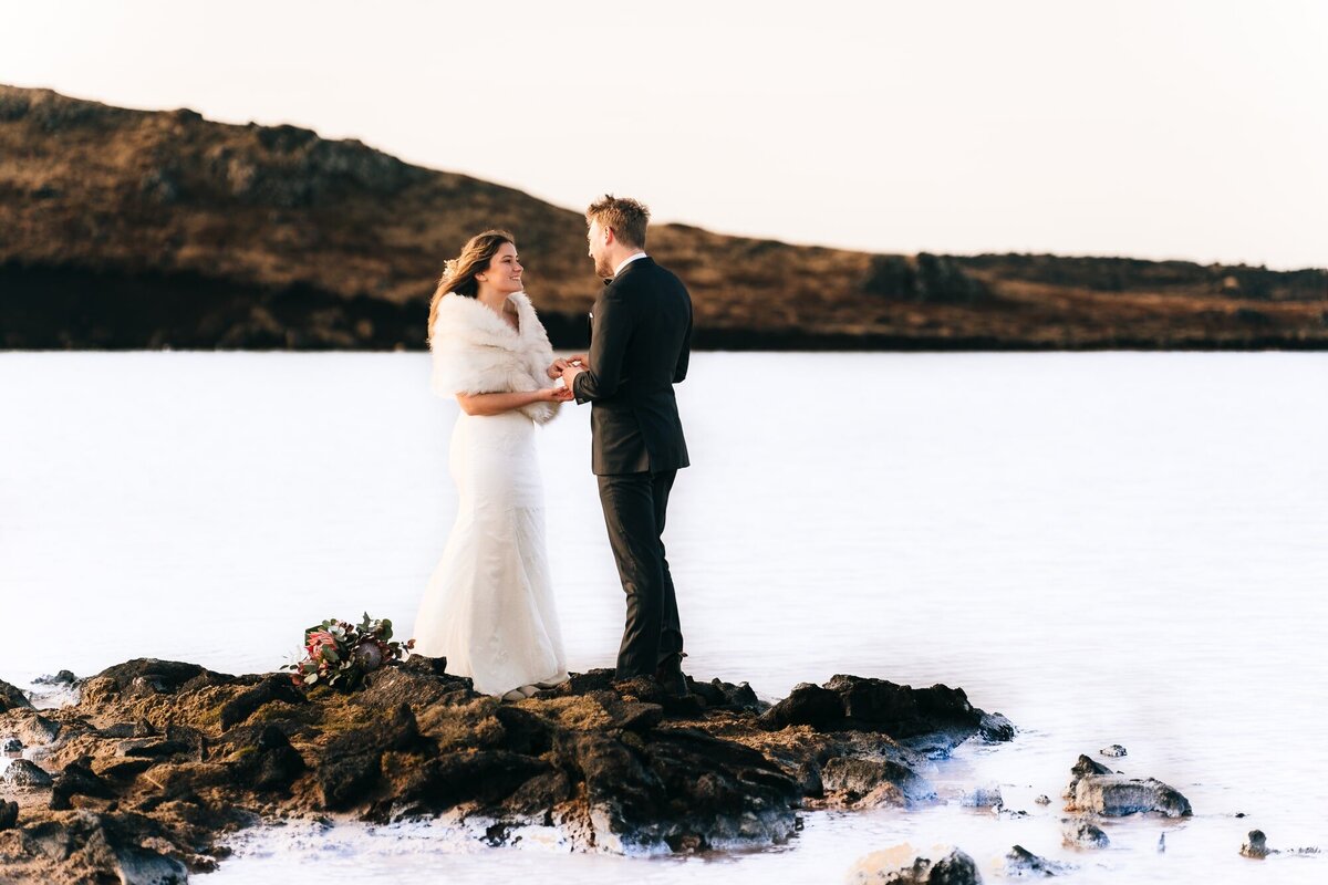 In the mesmerizing embrace of the Blue Lagoon in Iceland, the couple joyfully exchanges vows, surrounded by the beauty of nature and the promise of a lifetime together.