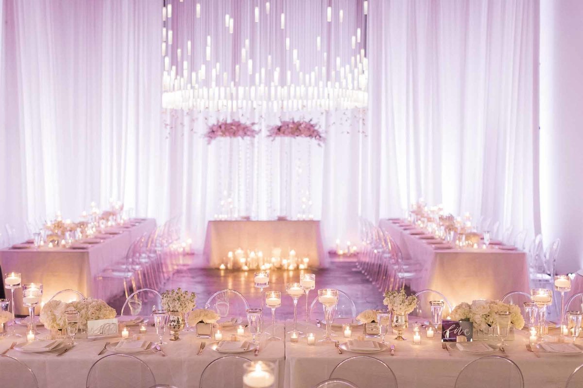 Lovely white wedding filled with light and candles make for a truly romantic evening