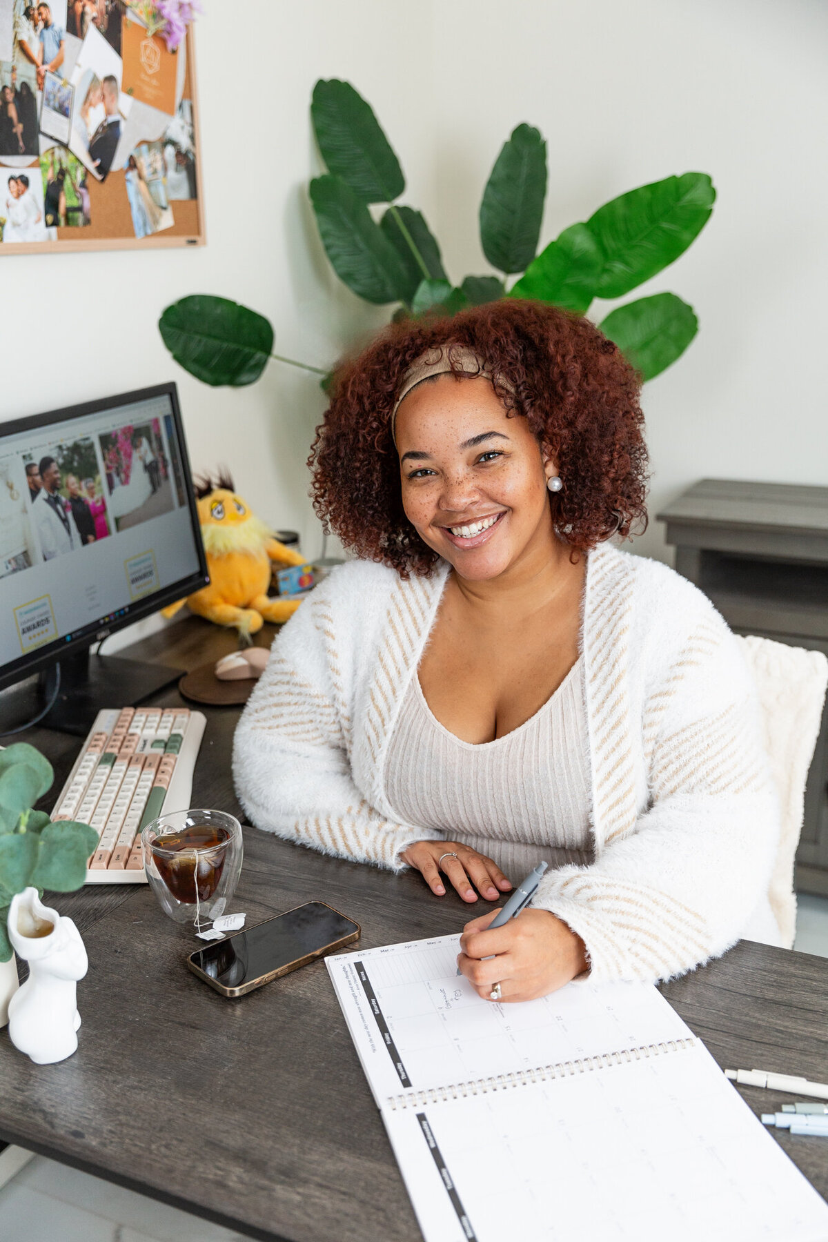 A-black-owned-business-woman-poses-during-branding-headshots-in-Baltimore-office-space