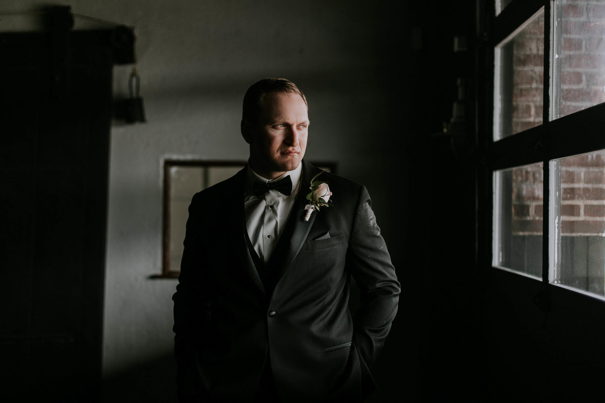 Groom stares out window at Biltwell Center