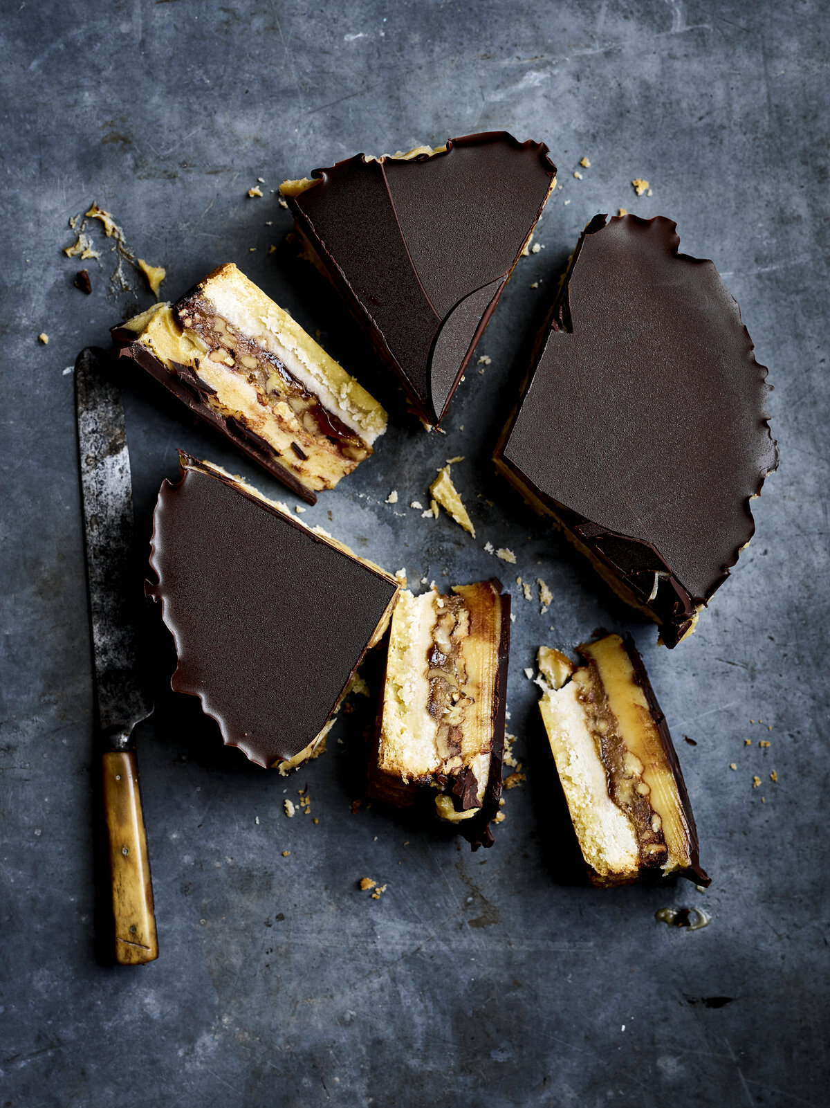 Millionaire shortbread tart with a layer of cream, chocolate, salted caramel and dark chocolate.