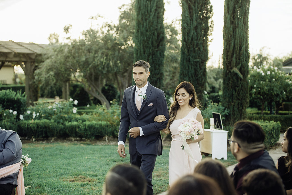 Wedding Photograph Of Groomsman And Bridesmaid Walking Los Angeles