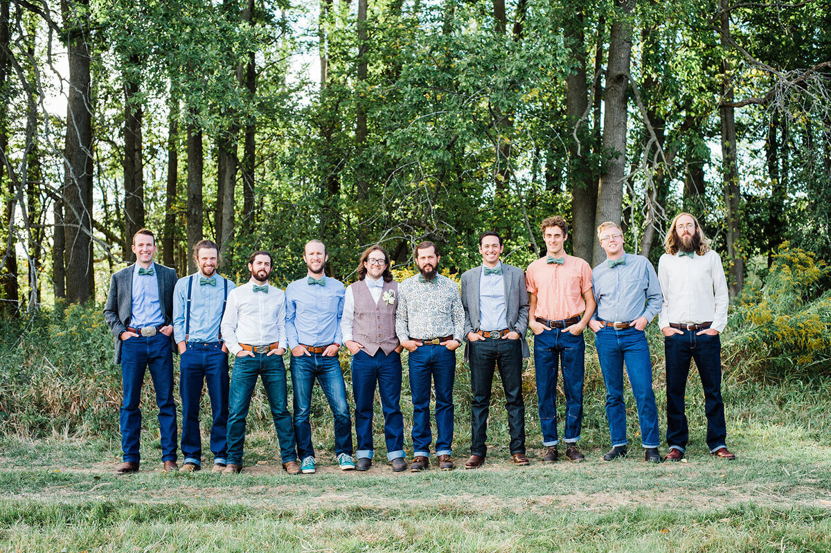 groomsmen standing in a line wearing jeans at vermont farm wedding burlington