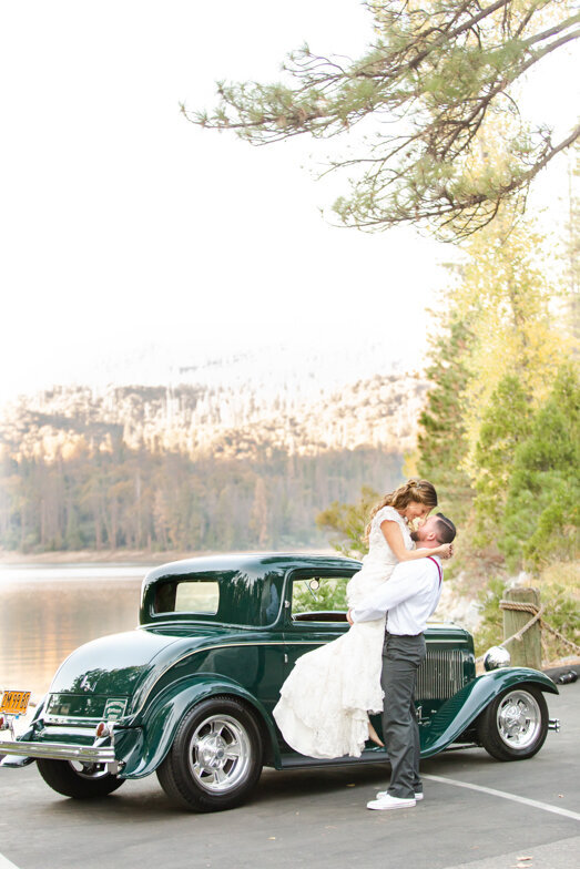 bride and groom in front of vintage car at Bass Lake wedding