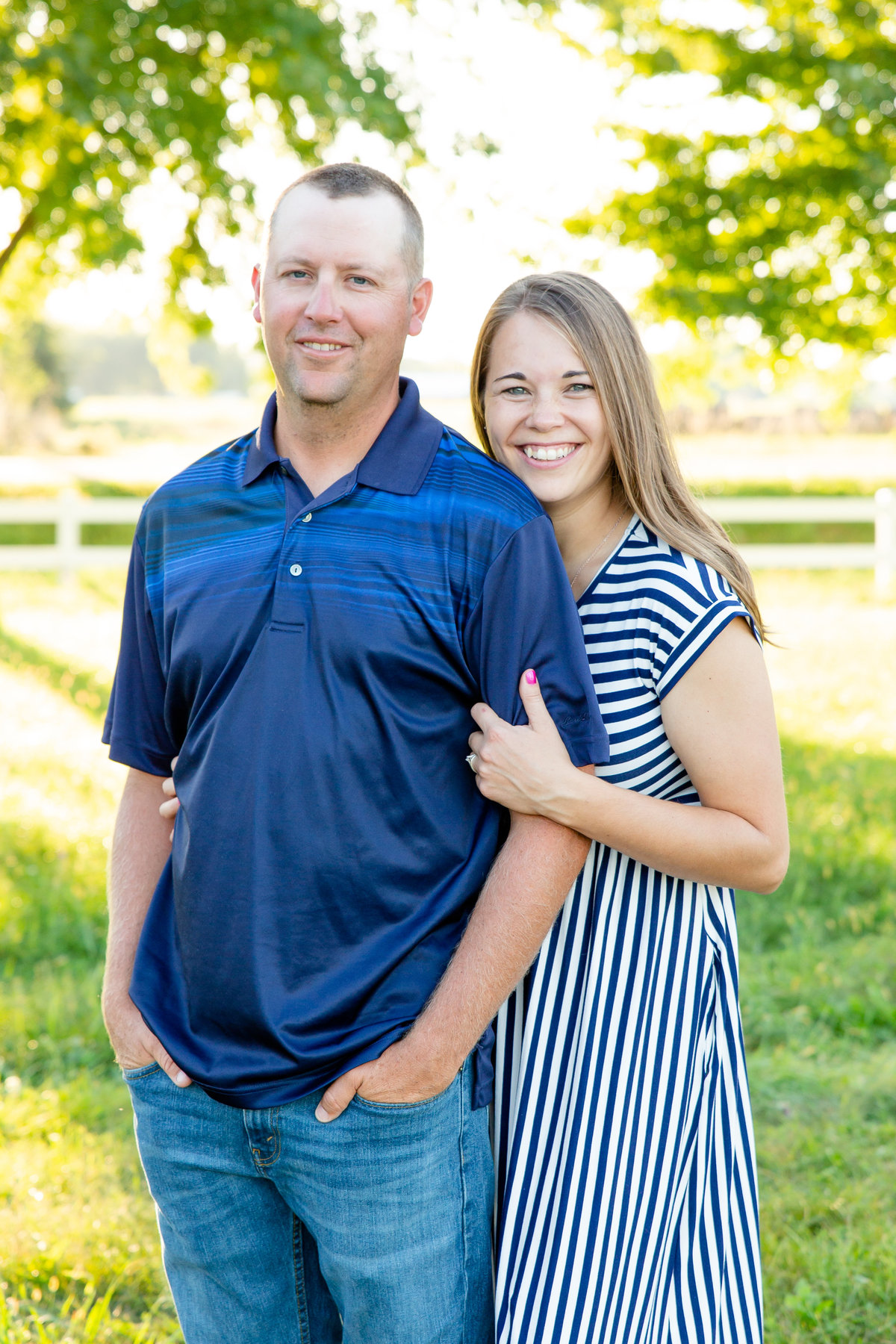 Couple poses at fairgrounds during fall family photos
