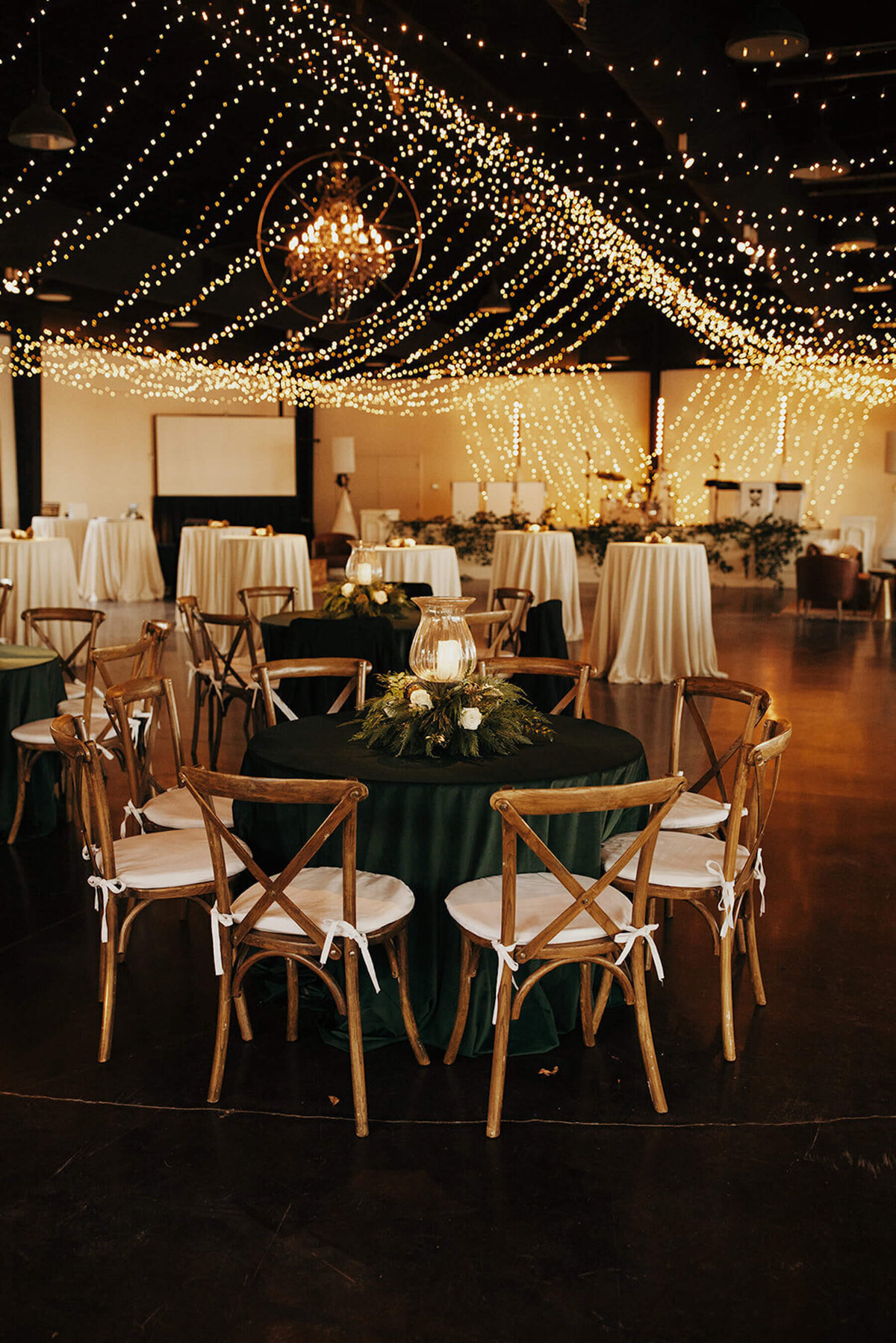 Green velvet linens and pinecones on wedding table
