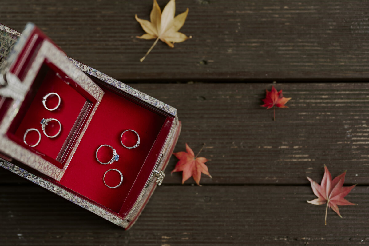 wedding rings in traditional korean jewelry box with autumn leaves