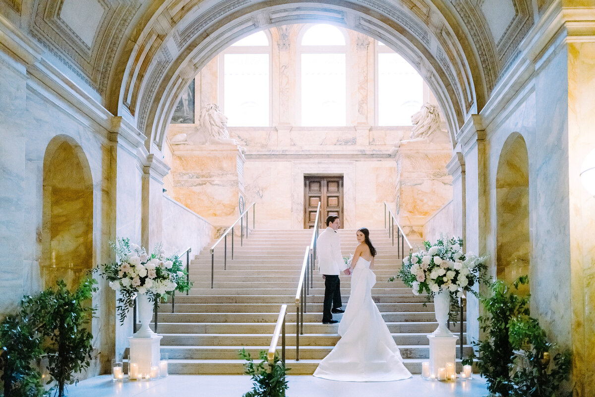 A wedding couple on the grand staircase of the Boston Public Library