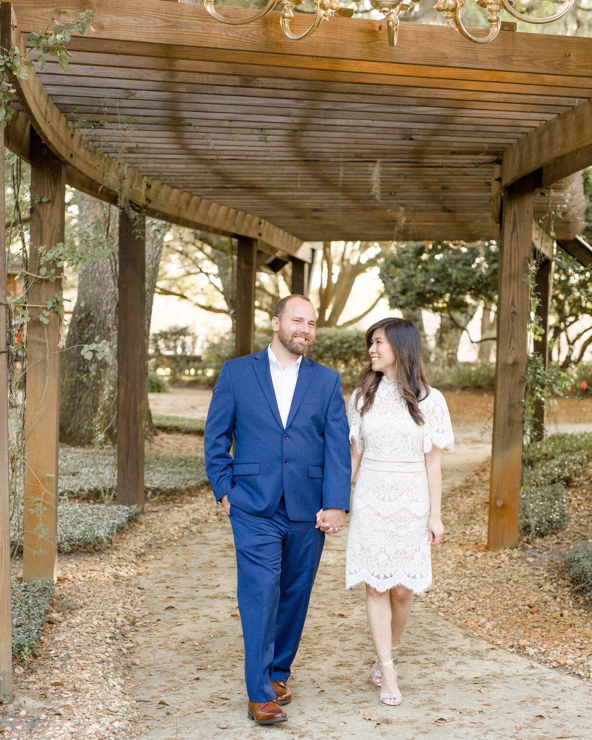 couple engagement session walkingby Lucas Mason Photography in Orlando, Windermere, Winder Garden area