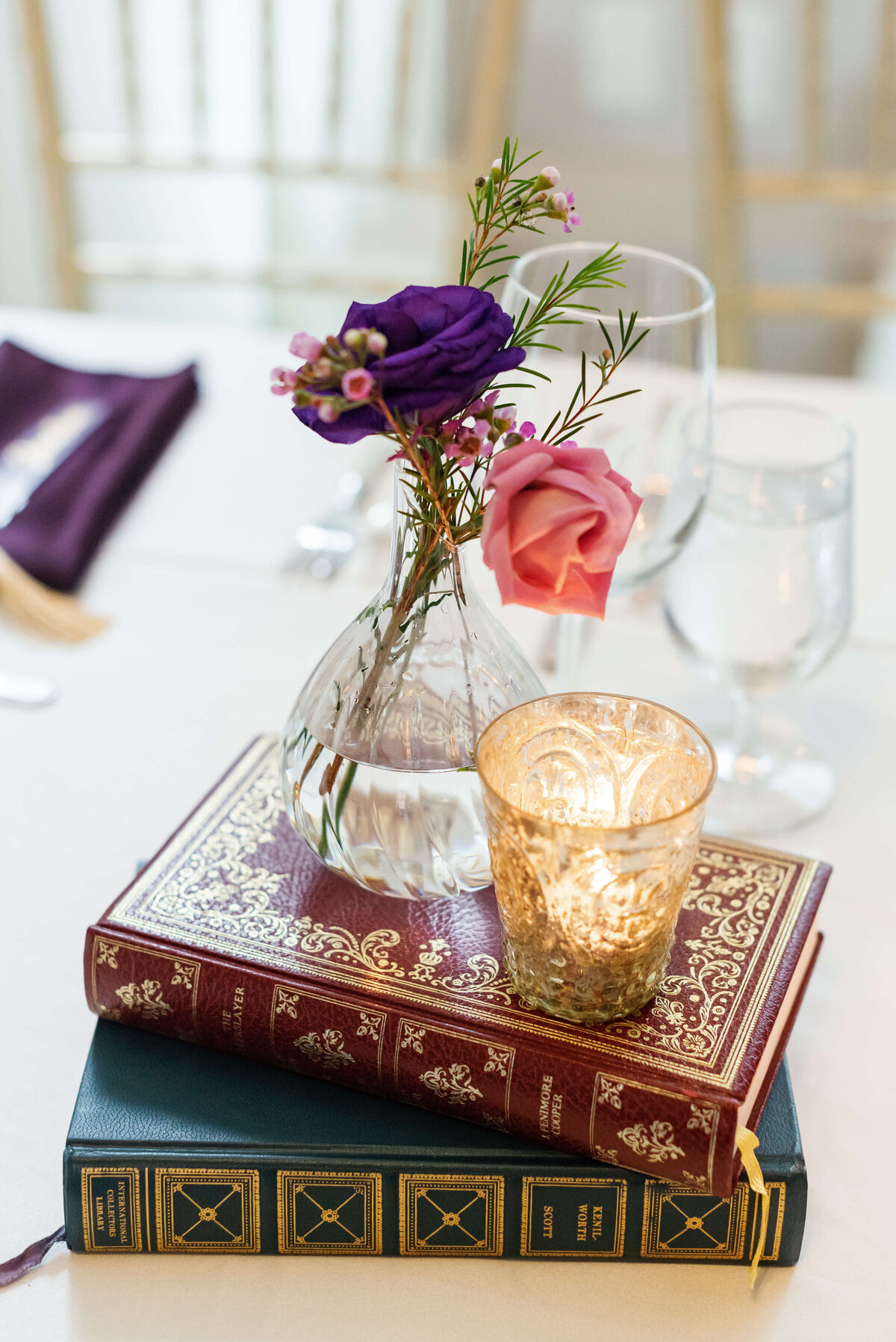 Vases and candles set upon two books at  at Halifax Club wedding in Nova Scotia