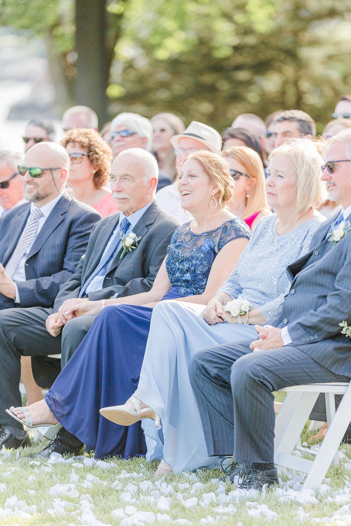 Lia Rose Weddings captures a candid image of guest laughing at a wedding ceremony.