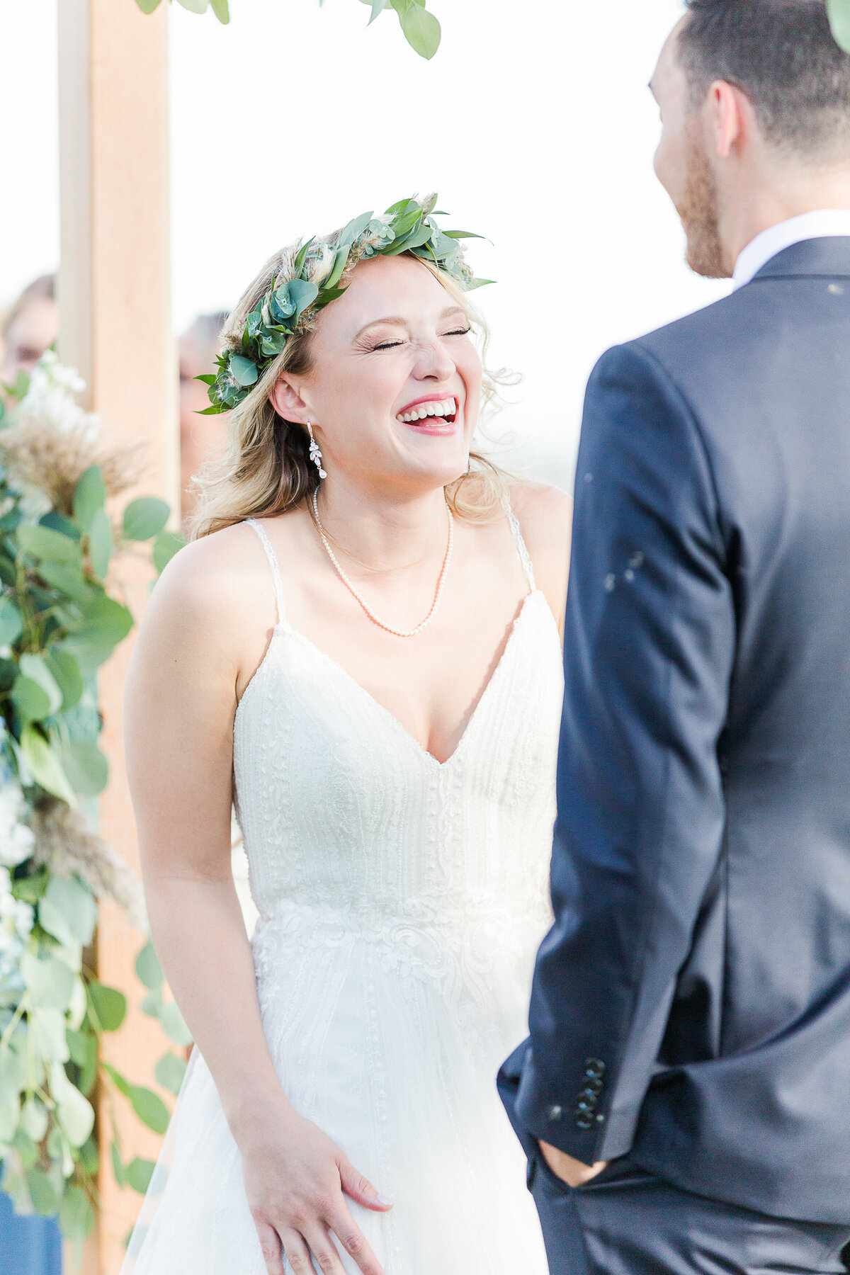 Bride is captured laughing during her wedding ceremony at the Madison Beach Hotel. Captured by best New England wedding photographer Lia Rose Weddings.