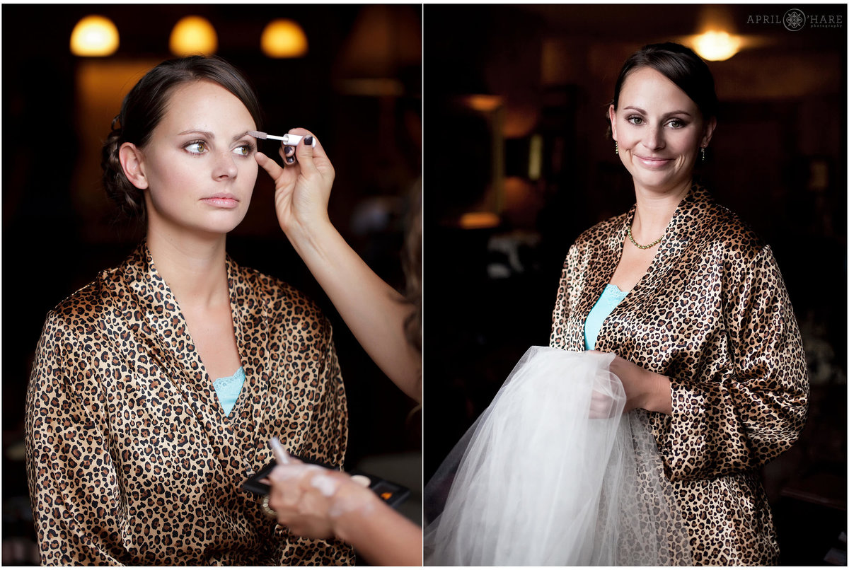 A bridemaid wearing a leopard print robe gets her make up done in the suite before the mountaintop wedding