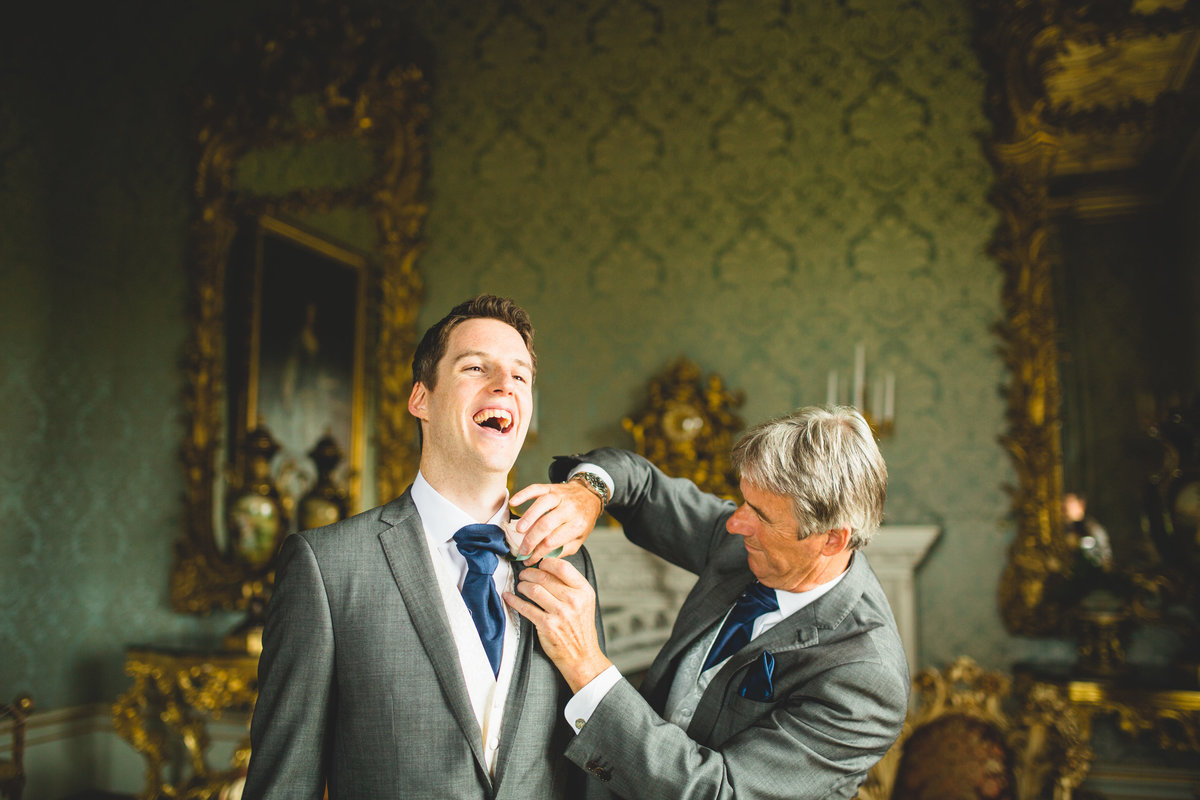 the father of the groom helping him get ready