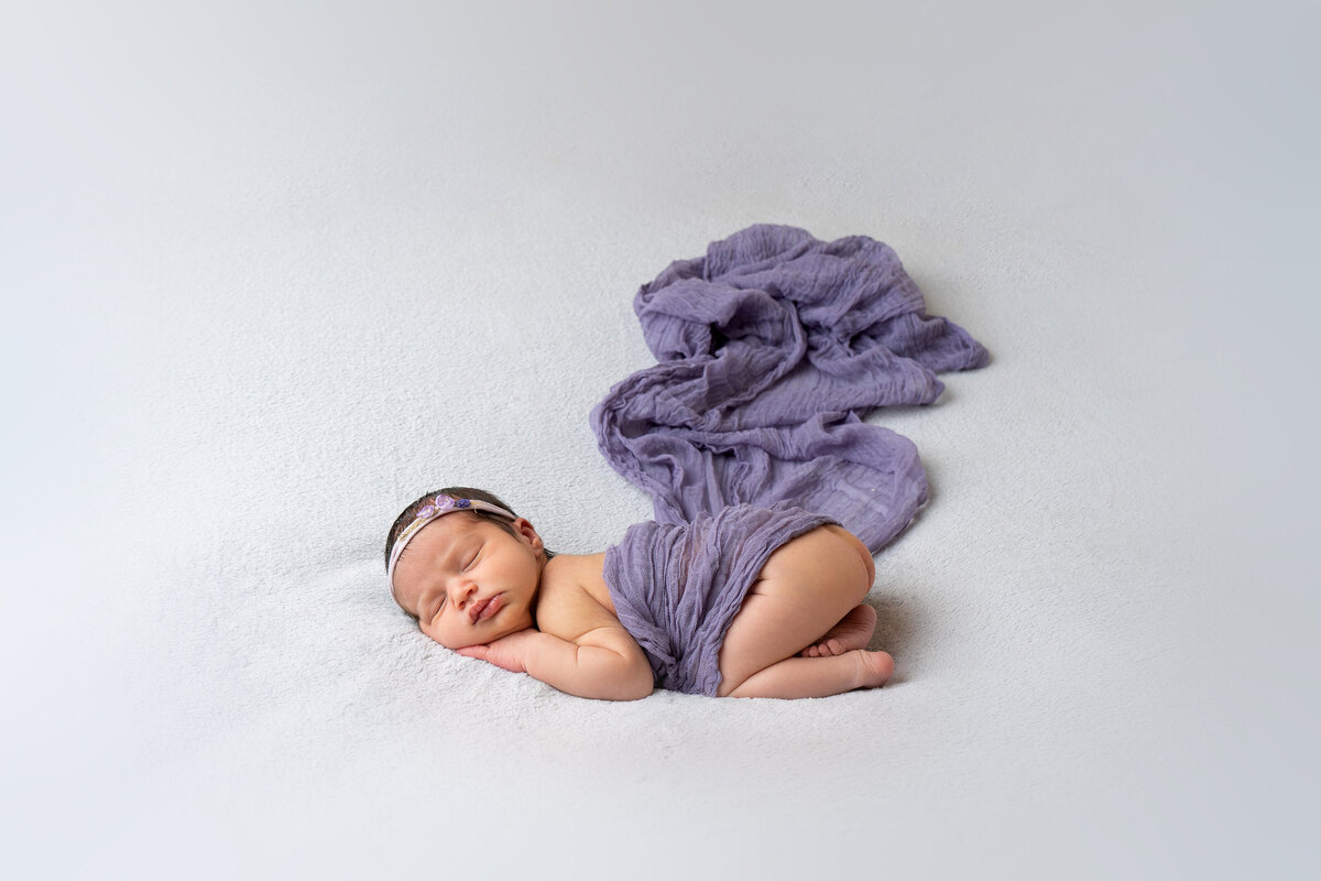 newborn-baby-under-lavender-blanket