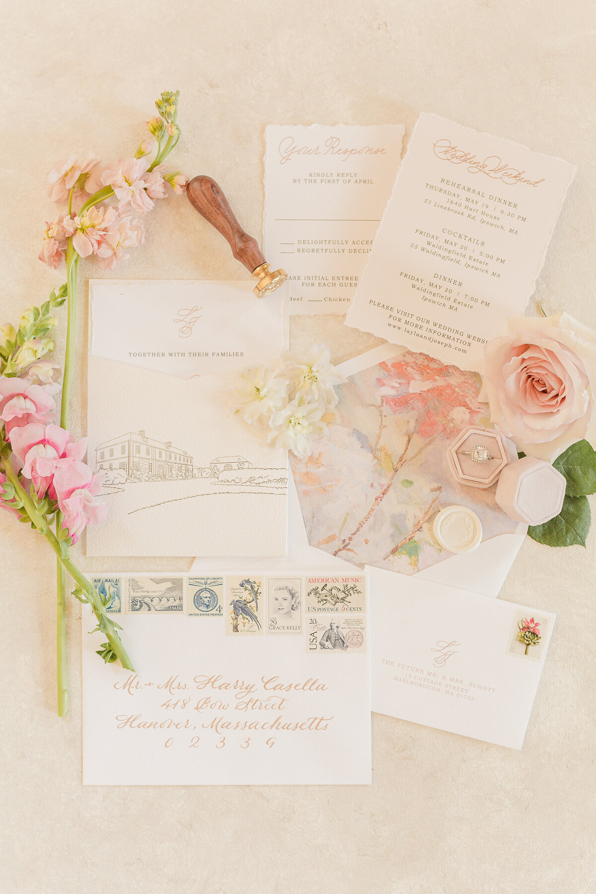Luxury flat lay featuring  wedding stationary, rings, and florals.