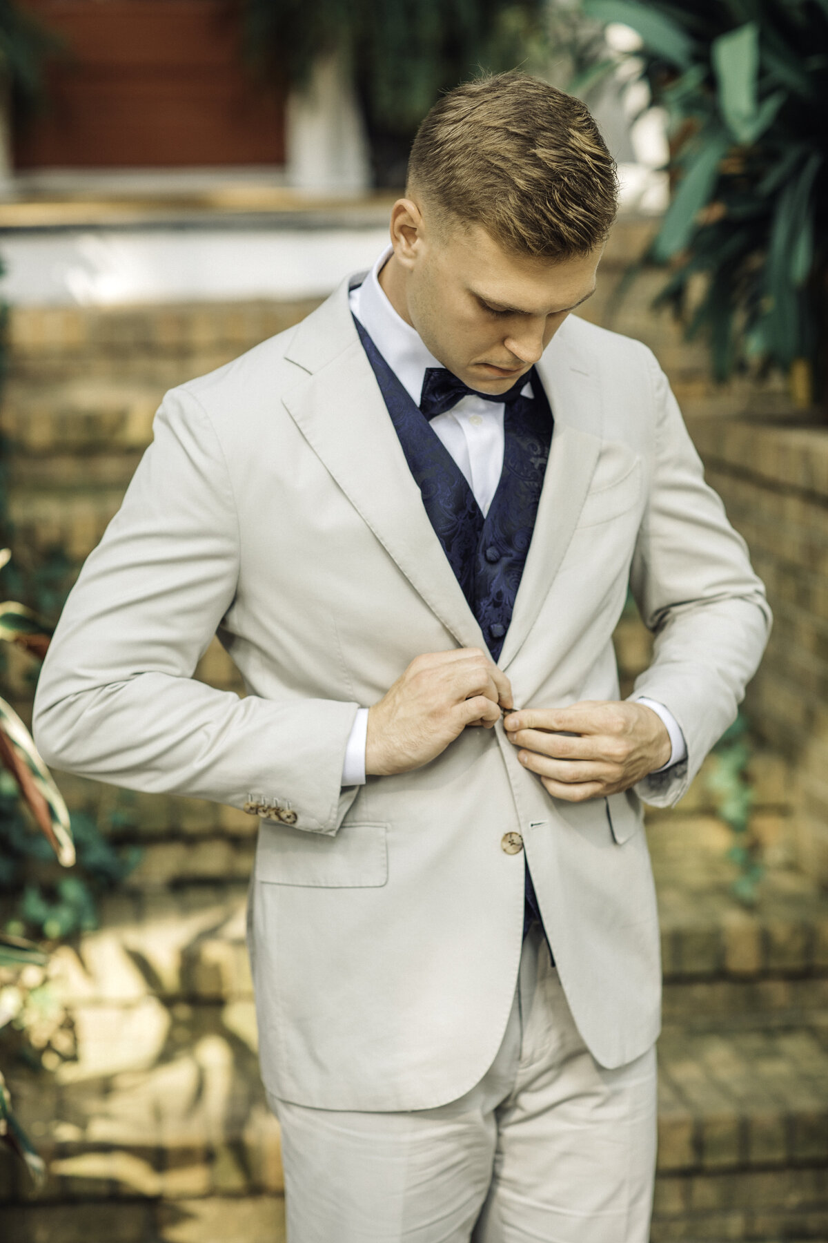 Wedding Photograph Of Groom Buttoning His Suit Los Angeles