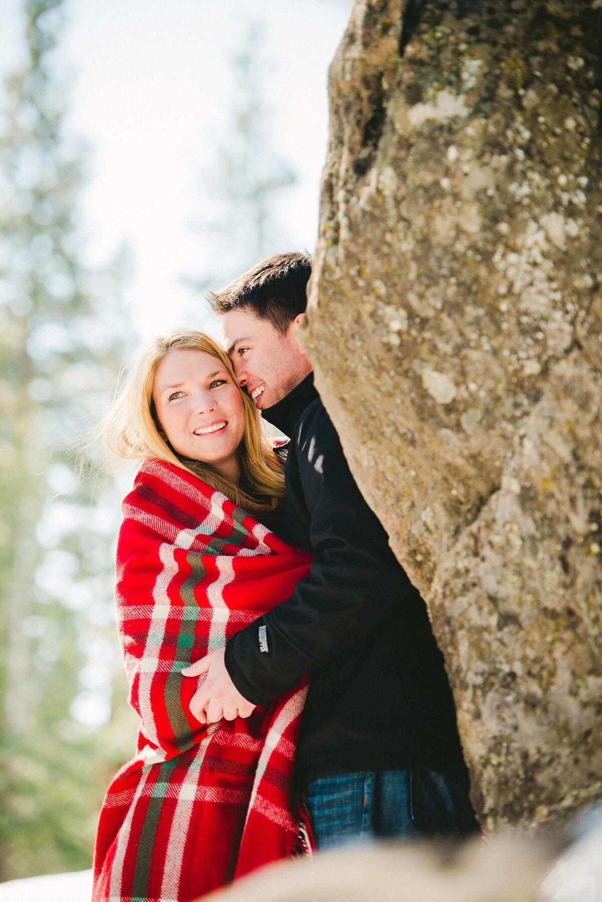 couple with plaid blanket during engagement session in Truckee
