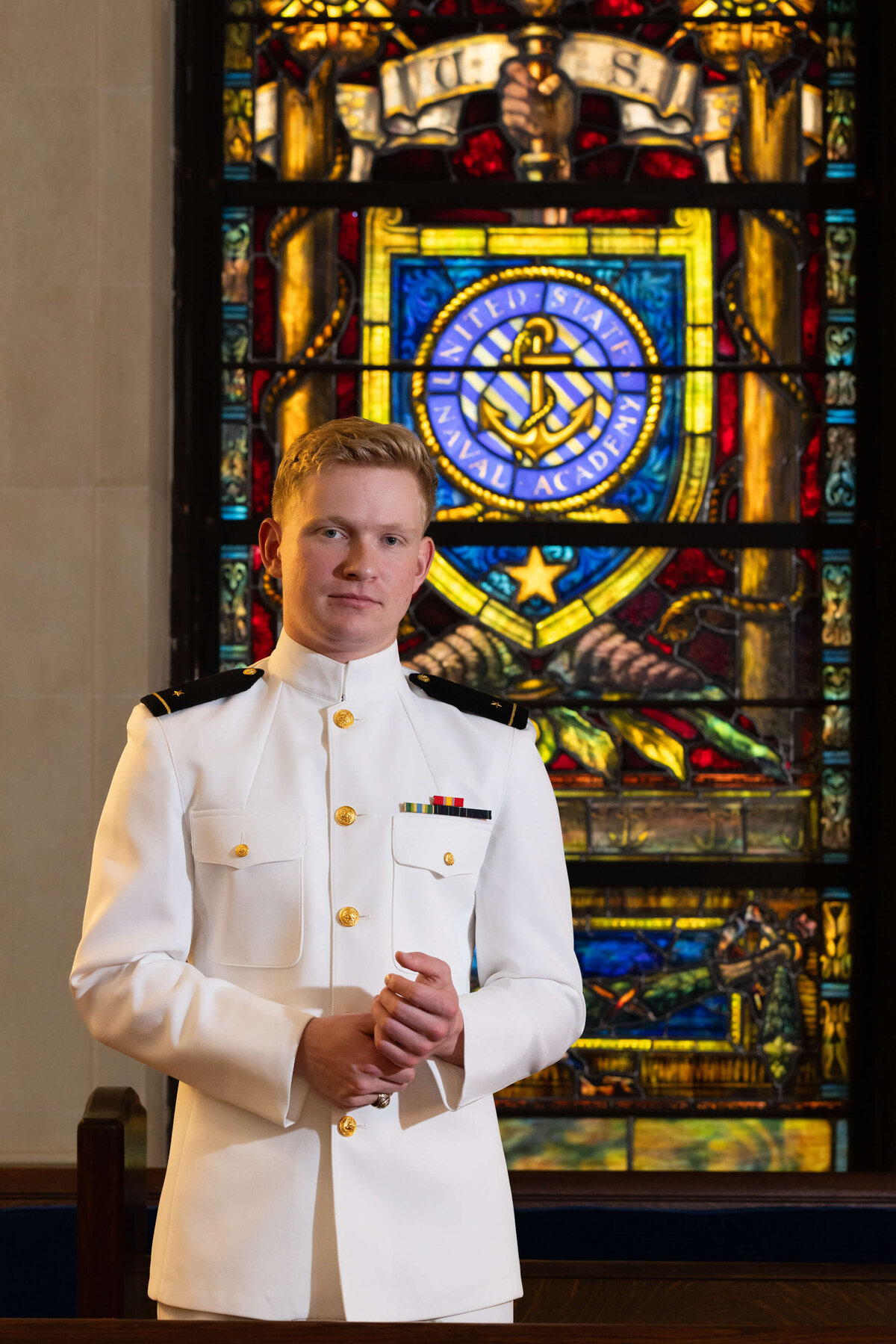 USNA Midshipman senior portrait with stained glass at the Naval Academy Chapel in Annapolis, Maryland.
