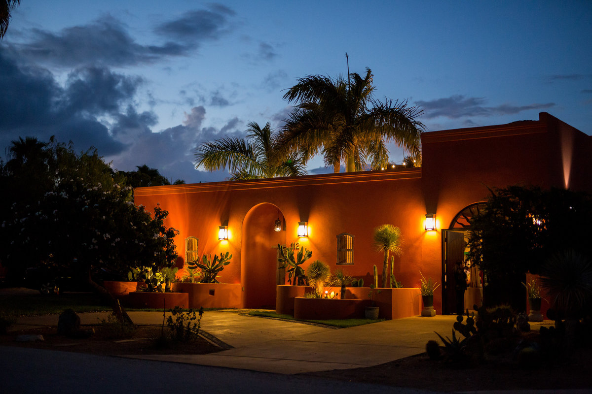 Exterior portrait of Casa Mariposa wedding venue at night during reception in South Padre Island beach wedding