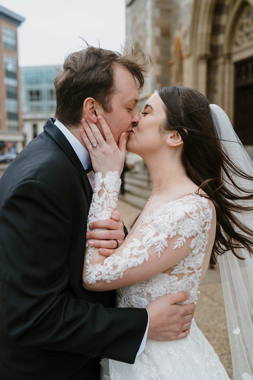 bride and groom kissing after their wedding ceremony in boston