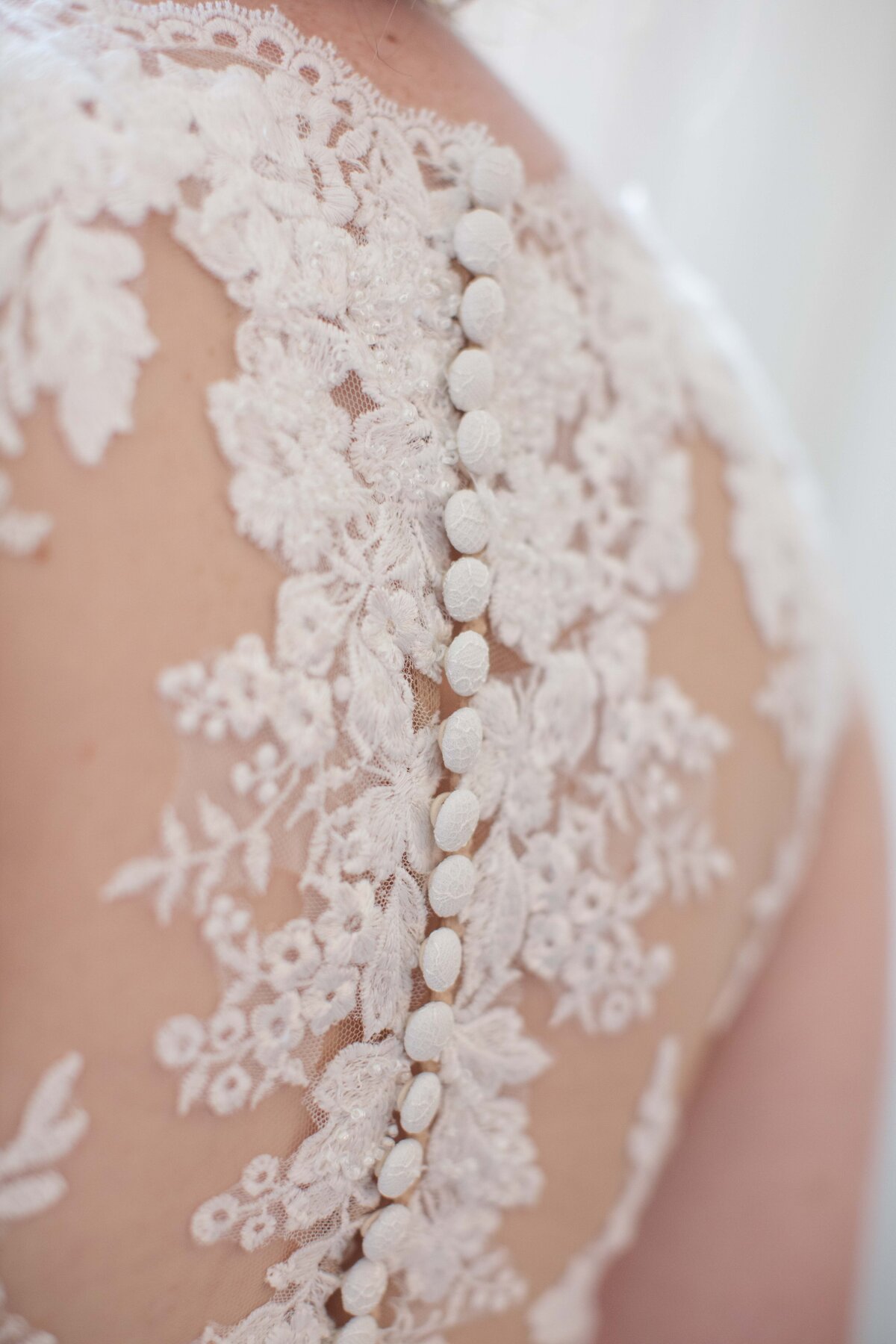 lace wedding dress detail with buttons by Firefly Photography