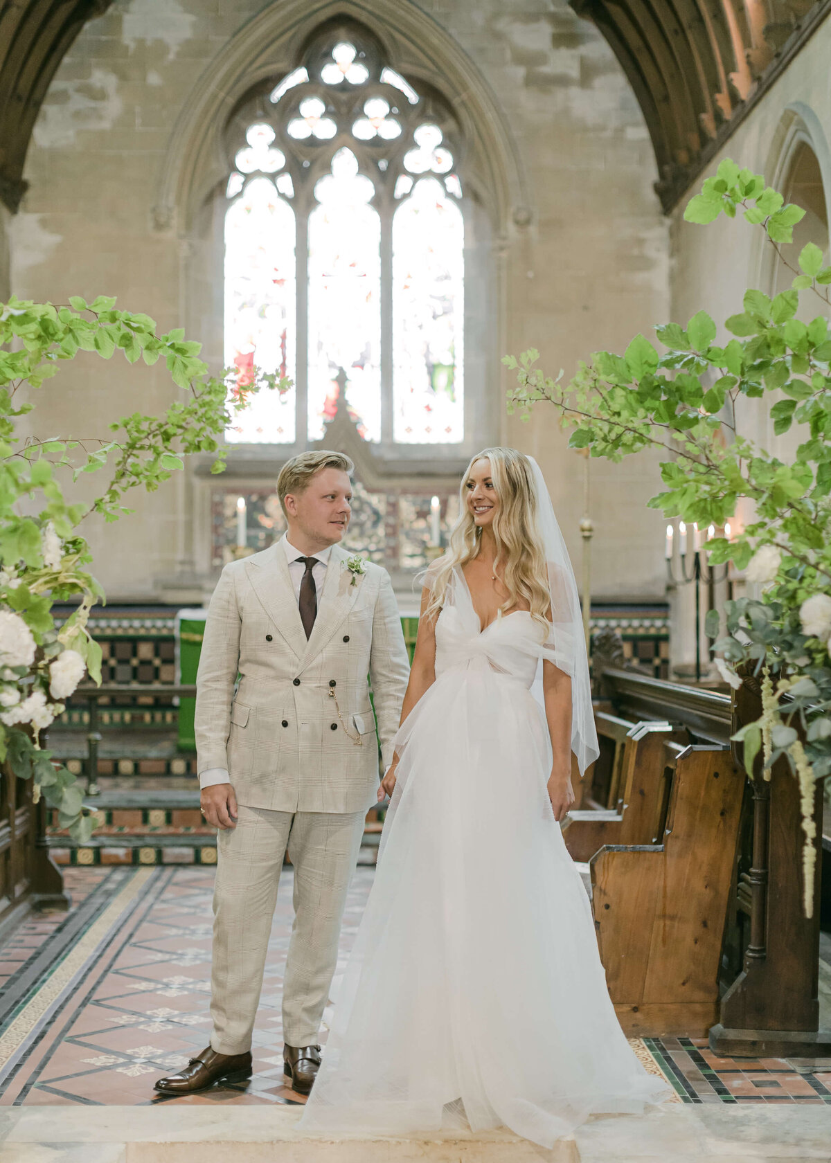 chloe-winstanley-weddings-church-bride-groom-altar-foliage