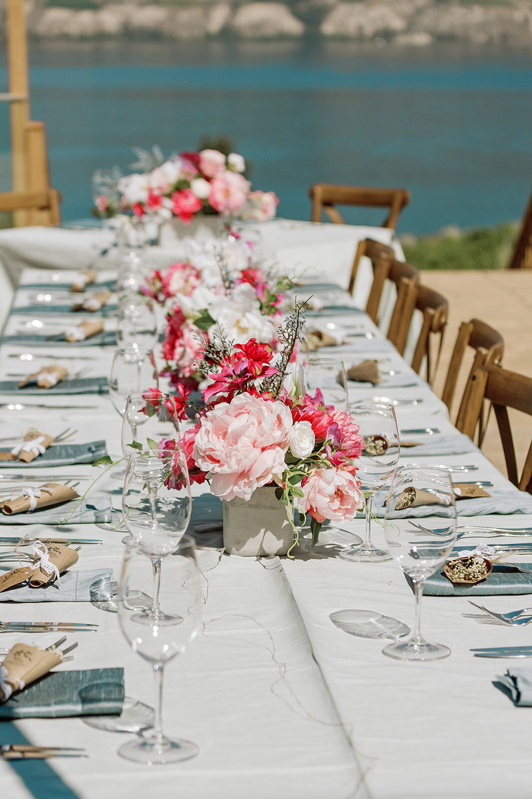 Pink wedding flowers on a blue tablecloth.