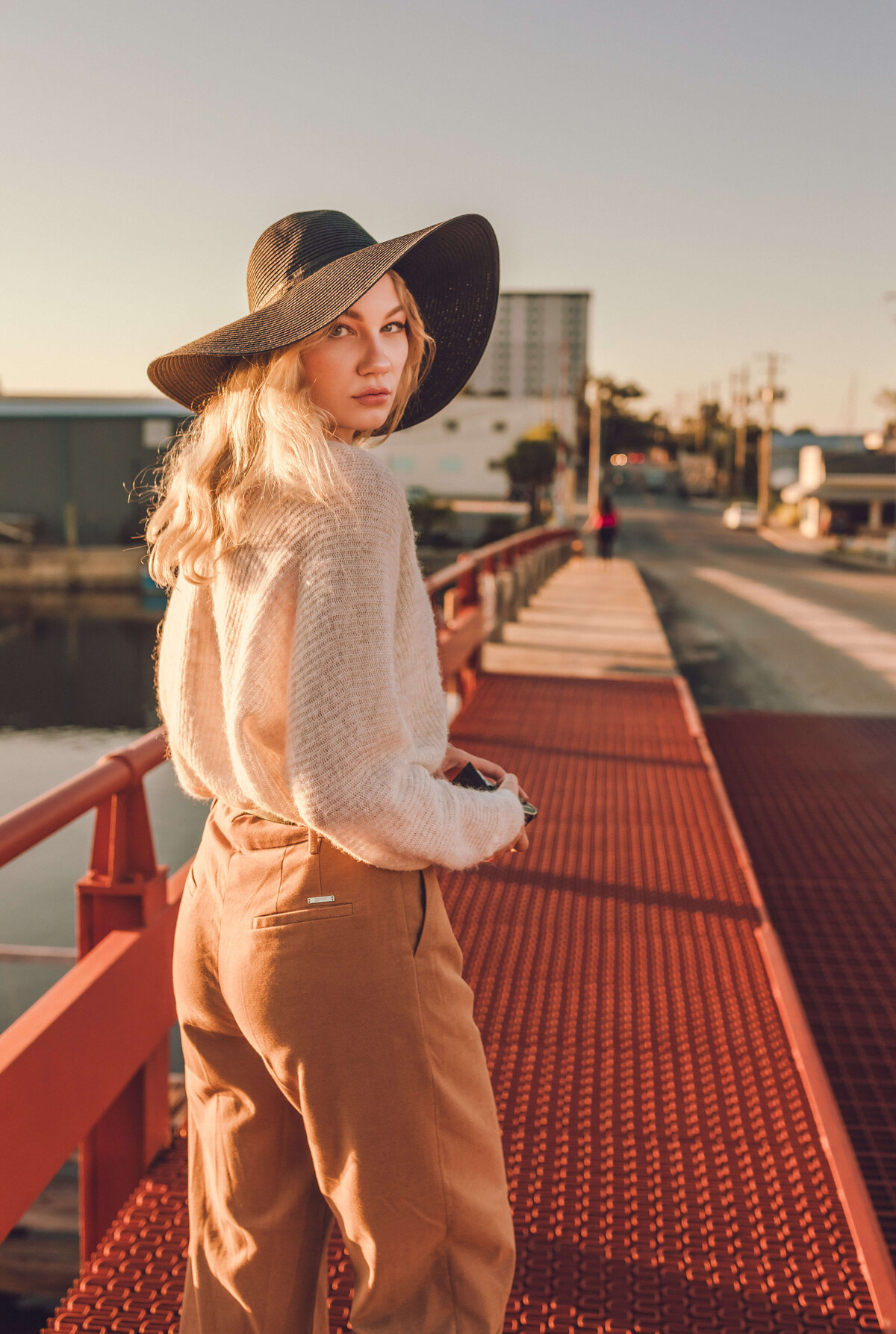 blonde girl walks across drawbridge downtown panama city fl