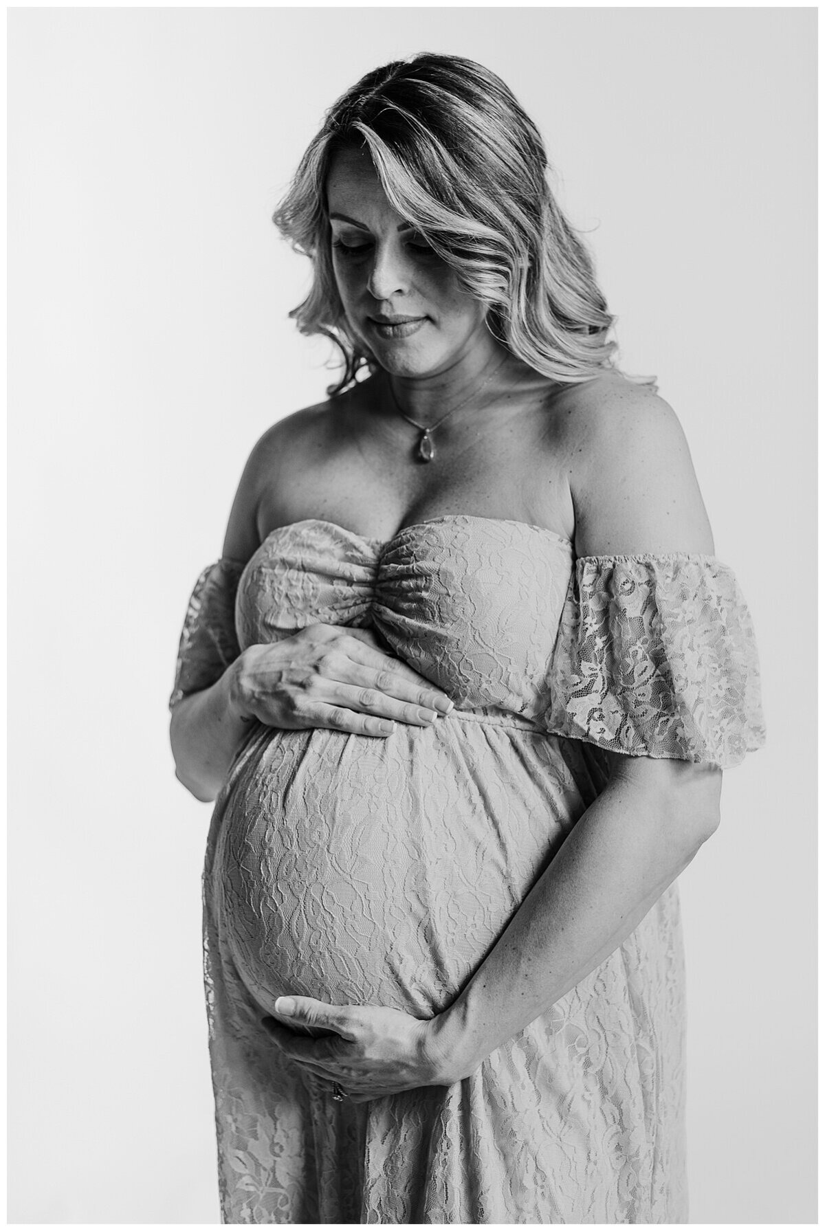 Mom to be showing off her beautiful baby bump in a blue dress during a maternity photoshoot in studio in Wexford PA