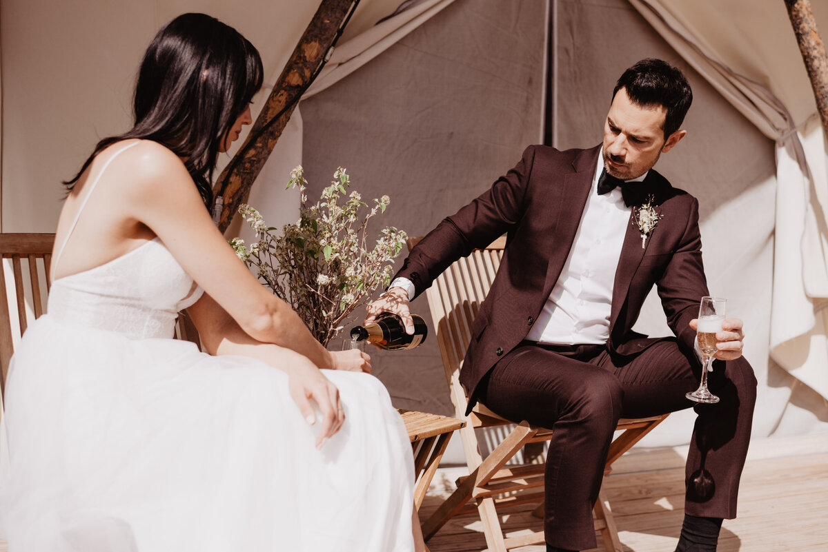 Utah elopement photographer captures groom sharing champagne with bride