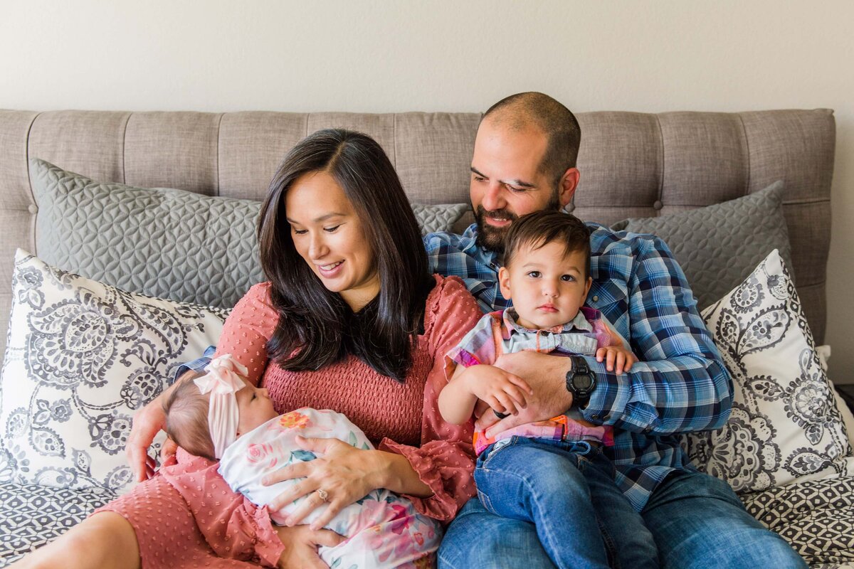 Newborn Lifestyle Session family on bed in Boulder, Colorado