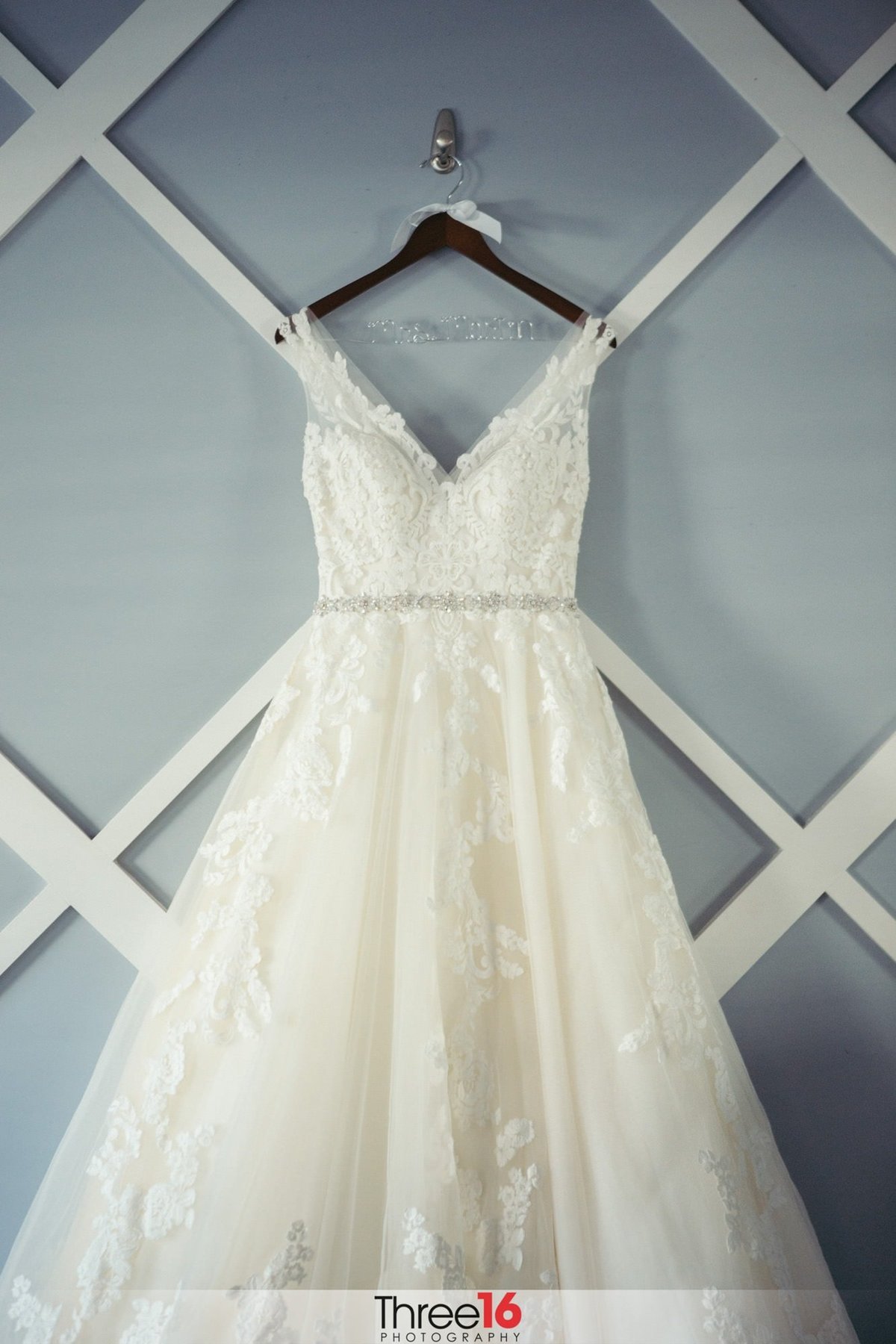 Gorgeous wedding gown hanging on display