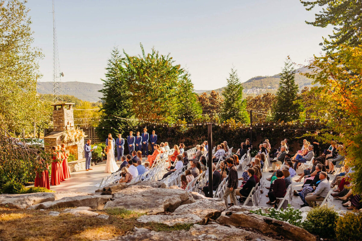 Photo of a ceremony at the venue Chattanooga with a stone fireplace and mountains