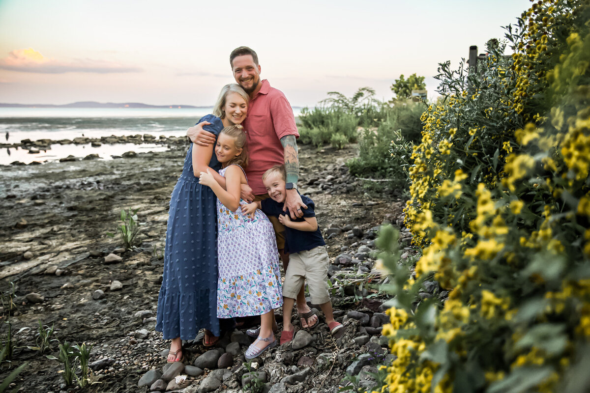 A Baltimore County family hugs during their lifestyle family photos with their photographer, Ingrid Berrios.