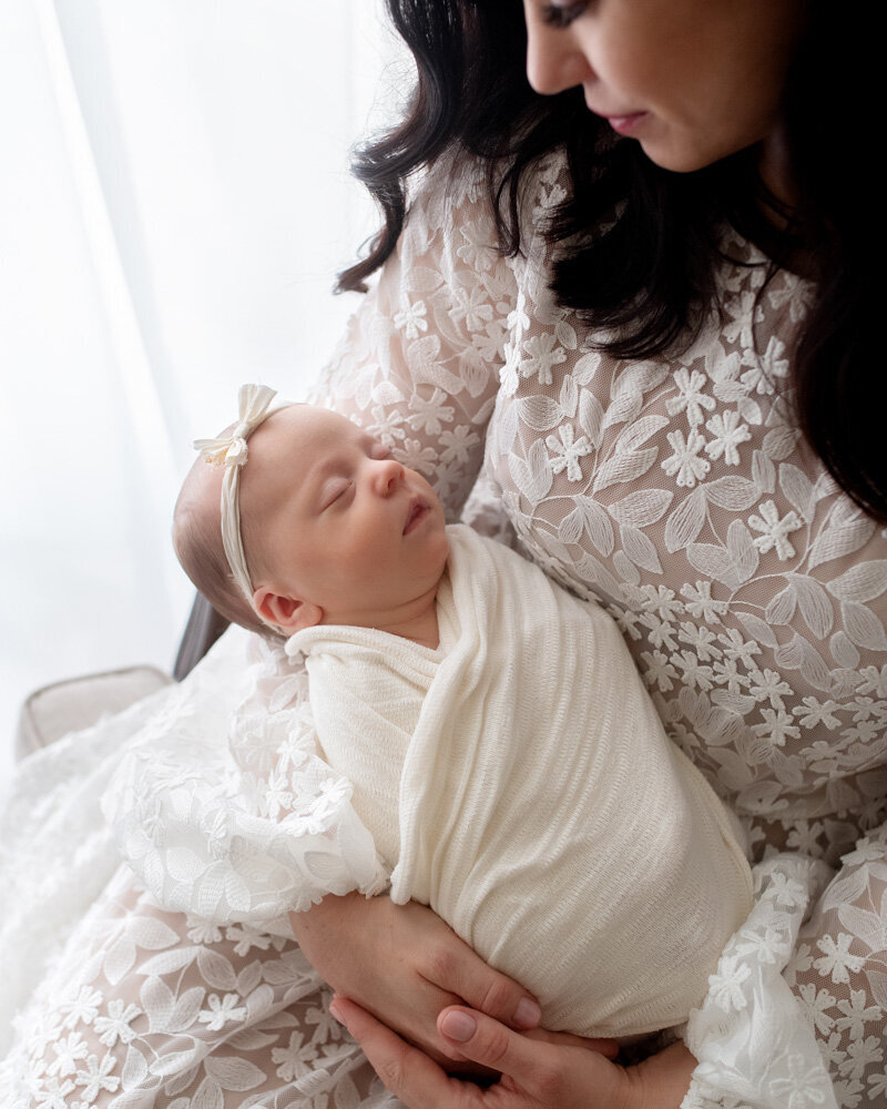 Newborn session of baby girl with mother in floral dress