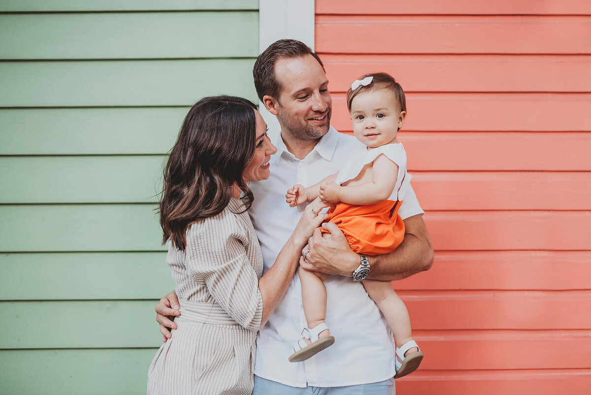 Family with baby in front of colorful houses in Fells Point Baltimore Maryland