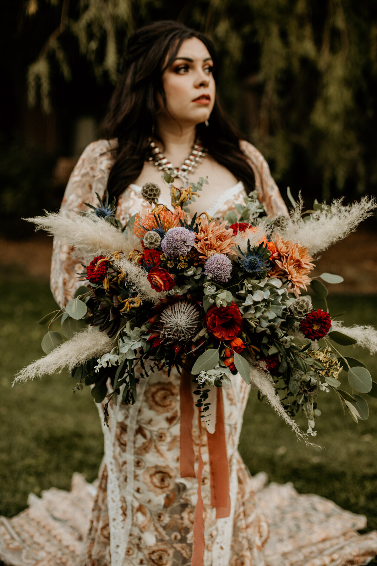 bride holding jewel tone bridal bouquet