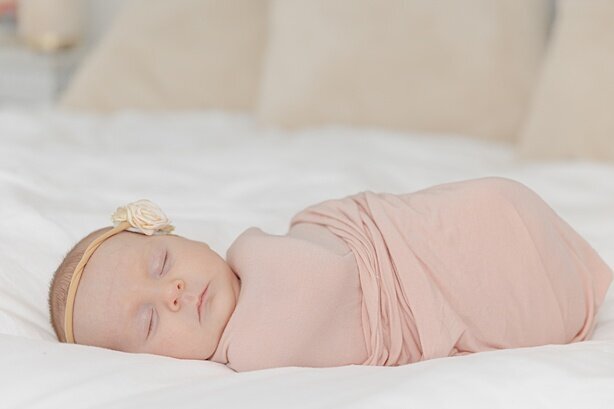 newborn baby in pink swaddle